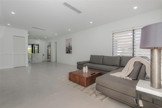 living room with recessed lighting, visible vents, and baseboards