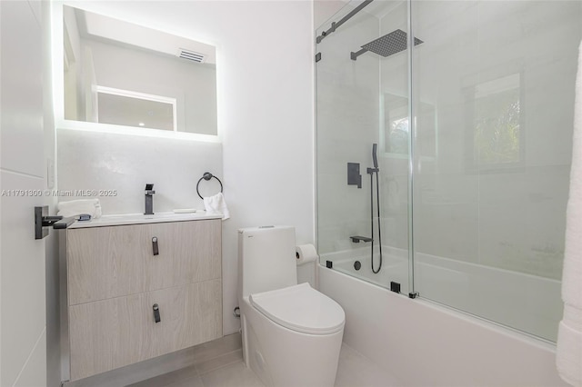 full bath with shower / bath combination with glass door, vanity, toilet, visible vents, and tile patterned flooring