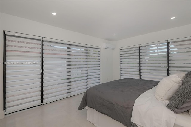 bedroom with recessed lighting and a wall mounted AC