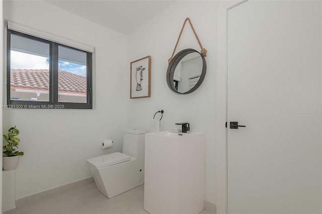 bathroom featuring toilet and a sink