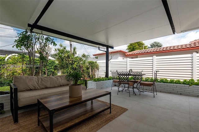 view of patio with fence, outdoor dining space, and outdoor lounge area
