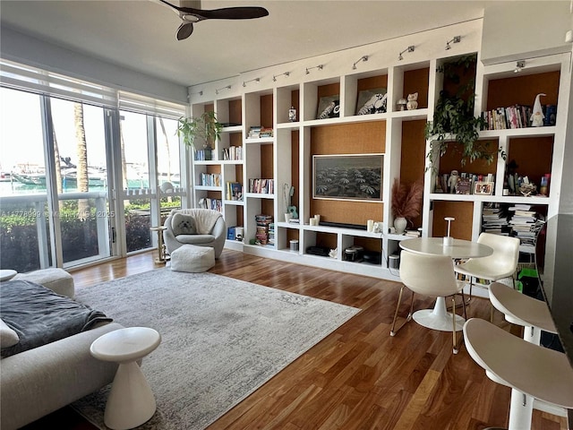 interior space with wood finished floors, ceiling fan, and built in features