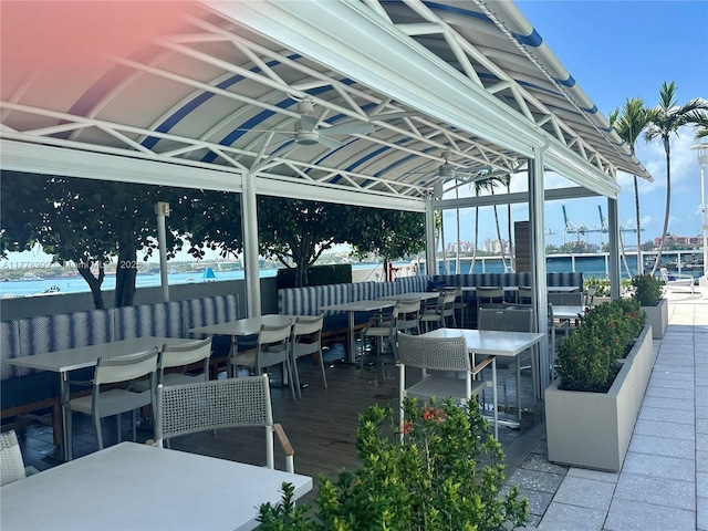 view of patio featuring outdoor dining space, a gazebo, and a ceiling fan
