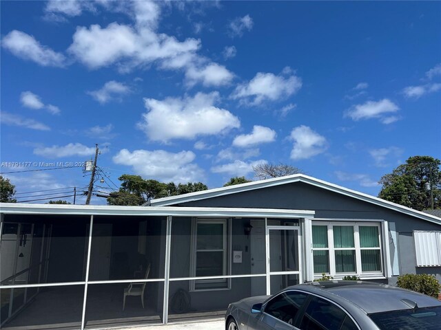 view of front facade featuring a sunroom