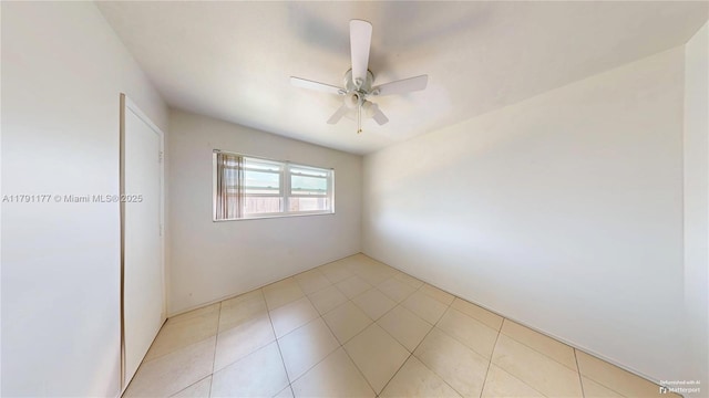 spare room with light tile patterned floors and ceiling fan