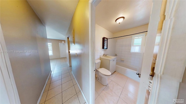 bathroom featuring tile patterned flooring, toilet, shower / bathtub combination, and vanity