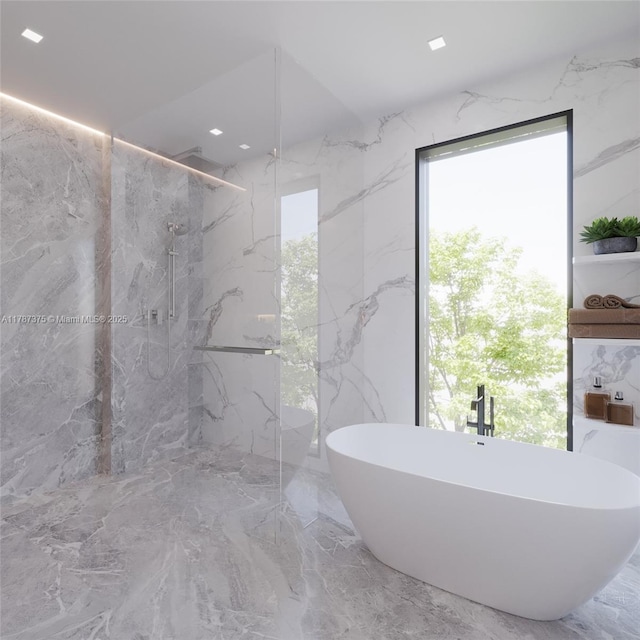 full bathroom with a healthy amount of sunlight, a soaking tub, marble finish floor, and a marble finish shower
