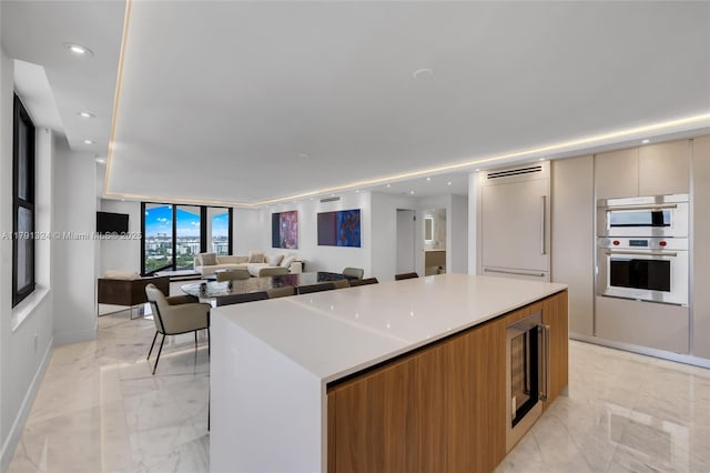 9801 Collins Ave Unit 17R, Bal Harbour, FL 33154 - kitchen with stainless steel double oven, a center island, modern cabinets, marble finish floor, and open floor plan