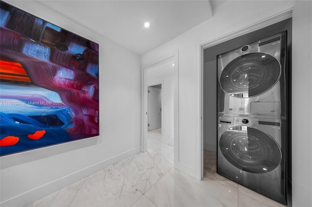 9801 Collins Ave Unit 17R, Bal Harbour, FL 33154 - washroom with baseboards, laundry area, stacked washer and dryer, and marble finish floor