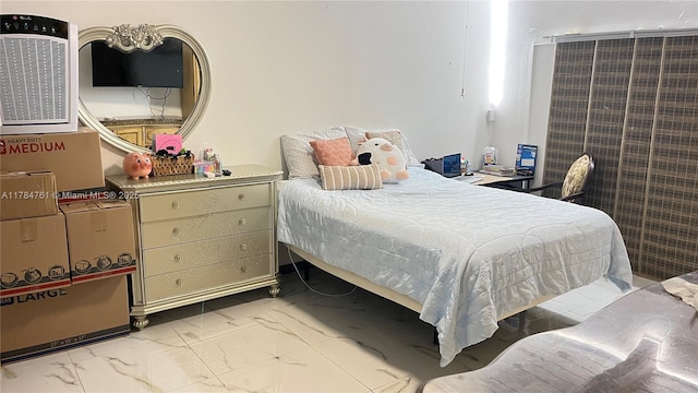 bedroom featuring marble finish floor