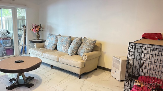 living room with baseboards and marble finish floor