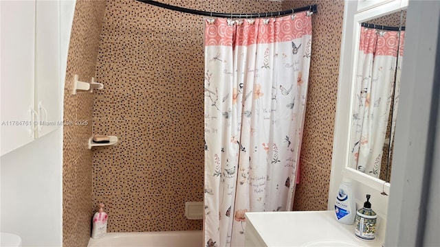 bathroom featuring shower / bathtub combination with curtain and vanity