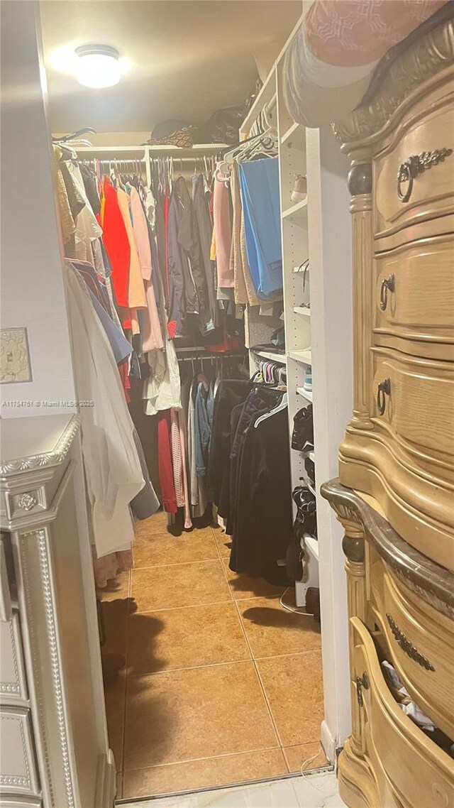 walk in closet featuring tile patterned flooring