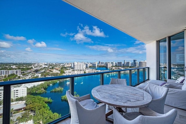 balcony featuring a view of city and a water view