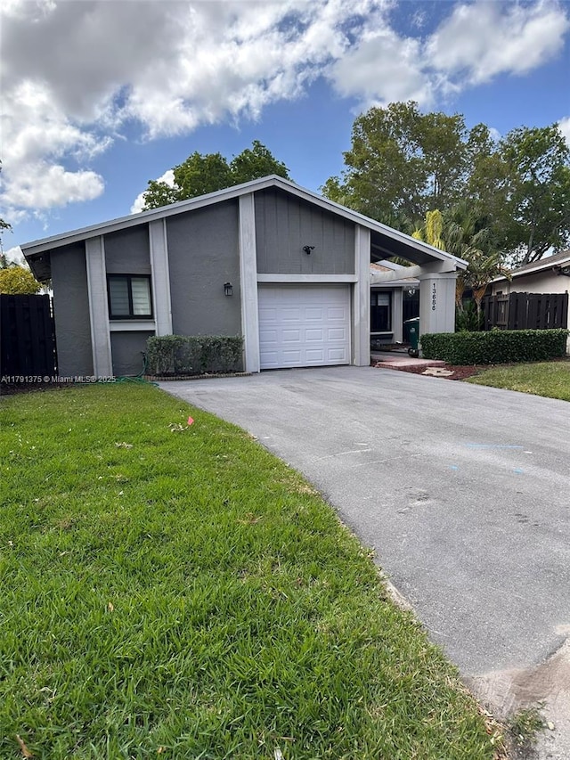 13686 SW 116th Ln, Miami, FL 33186 - view of front of home featuring a front lawn, an attached garage, aphalt driveway, and fence
