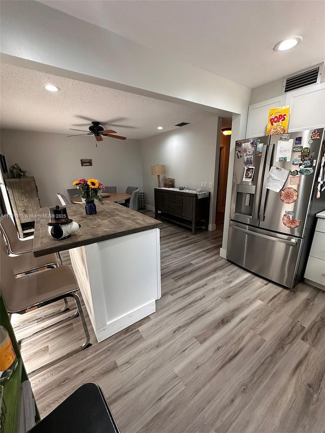 13686 SW 116th Ln, Miami, FL 33186 - kitchen featuring white cabinetry, visible vents, light wood finished floors, a ceiling fan, and stainless steel fridge with ice dispenser