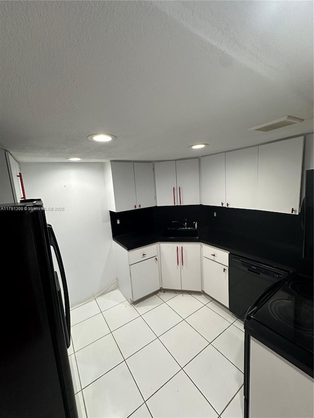 3301 Spanish Moss Ter Unit 302, Lauderhill, FL 33319 - kitchen with black appliances, a textured ceiling, light tile patterned flooring, white cabinetry, and a sink