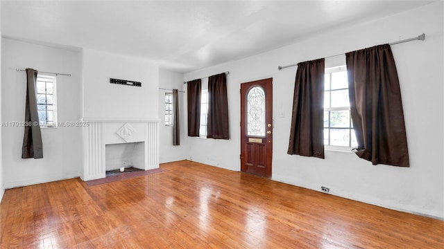 unfurnished living room featuring wood finished floors and a fireplace