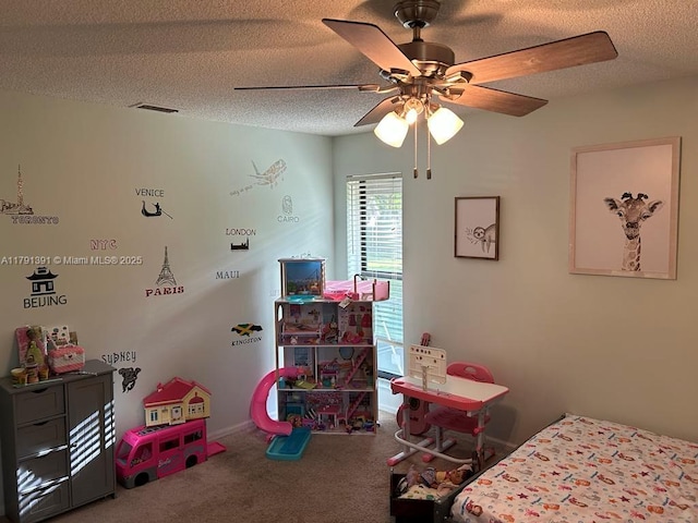 carpeted bedroom with a textured ceiling and a ceiling fan