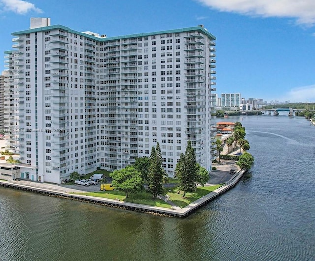 exterior space with a water view and a city view