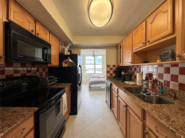 301 174th St Unit 1105, Sunny Isles Beach, FL 33160 - kitchen with black appliances, a sink, backsplash, and brown cabinets