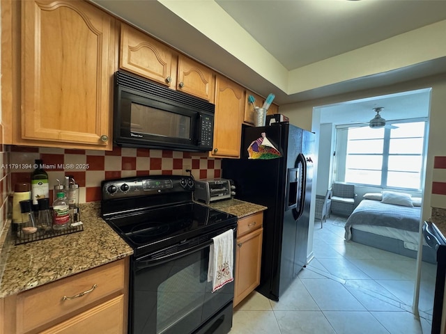 301 174th St Unit 1105, Sunny Isles Beach, FL 33160 - kitchen with black appliances, decorative backsplash, light stone counters, and ceiling fan