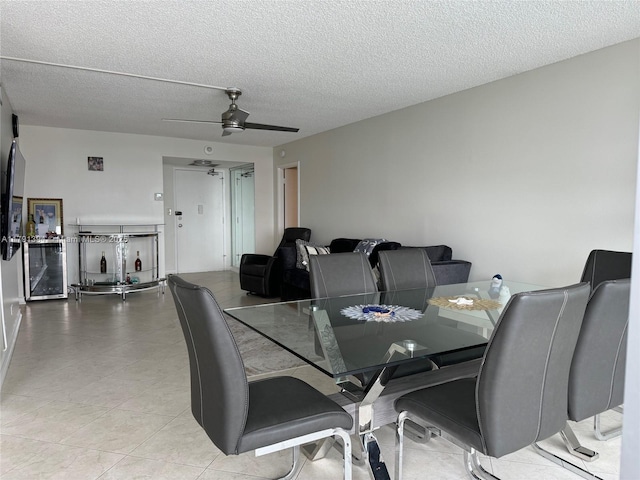 dining area featuring a textured ceiling and ceiling fan