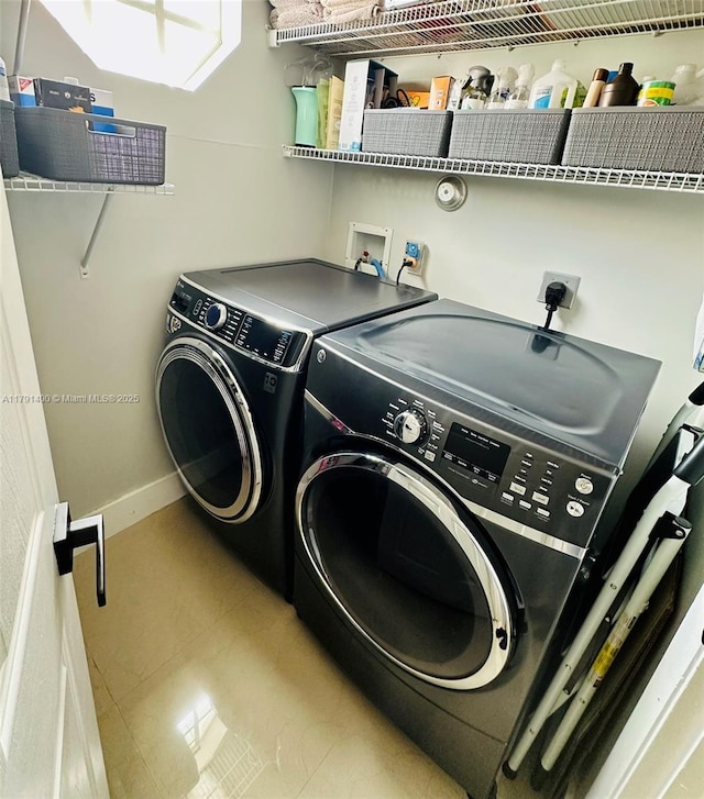 laundry room with independent washer and dryer, laundry area, and baseboards