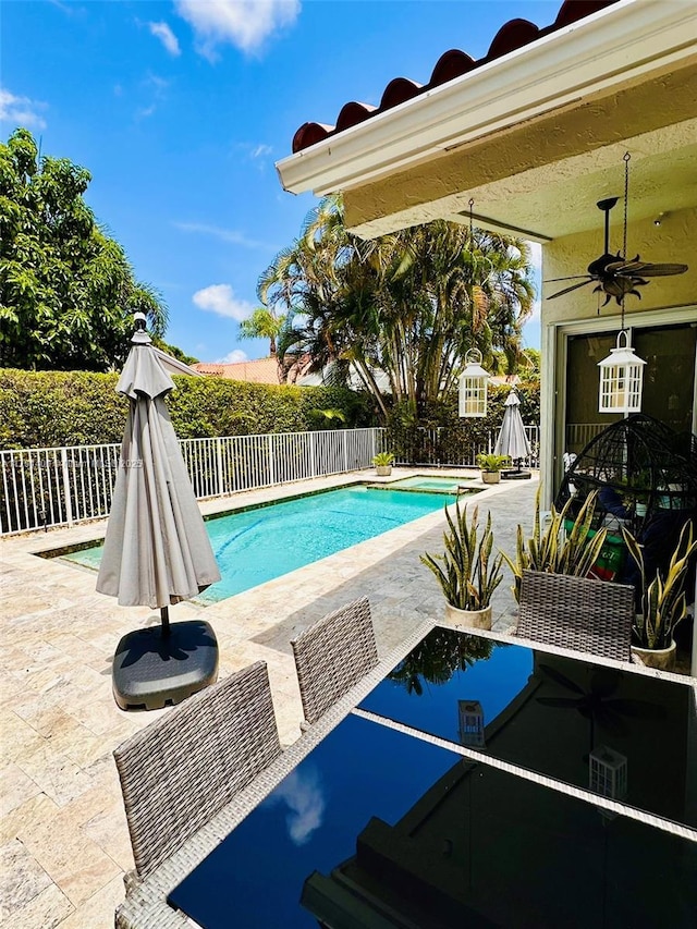 view of swimming pool featuring a fenced in pool, a ceiling fan, a patio area, and a fenced backyard
