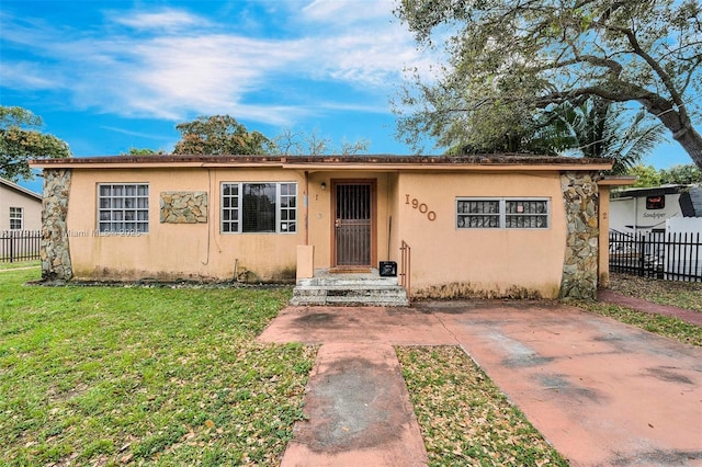1900 NW 88th St, Miami, FL 33147 - view of front of property featuring a front lawn, stucco siding, and fence
