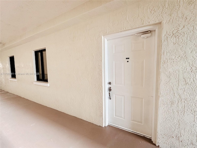 view of exterior entry featuring stucco siding