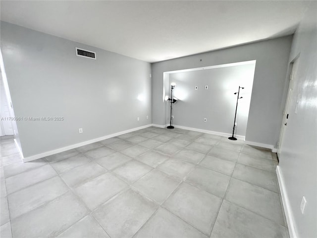 empty room with visible vents and baseboards