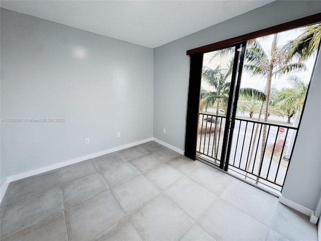 unfurnished room with baseboards