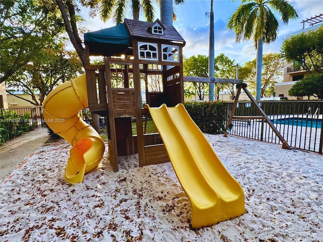 view of play area featuring a fenced in pool and fence