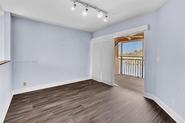 23140 Island Vw Unit 3, Boca Raton, FL 33433 - empty room featuring baseboards, rail lighting, dark wood-style flooring, and ceiling fan