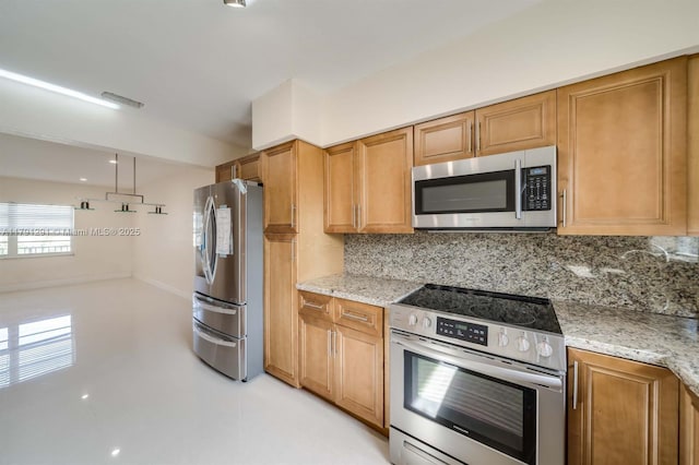 2600 S Ocean Dr Unit S314, Hollywood, FL 33019 - kitchen with light stone counters, finished concrete flooring, brown cabinets, decorative backsplash, and appliances with stainless steel finishes