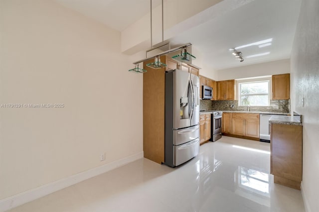2600 S Ocean Dr Unit S314, Hollywood, FL 33019 - kitchen with baseboards, backsplash, appliances with stainless steel finishes, and a sink