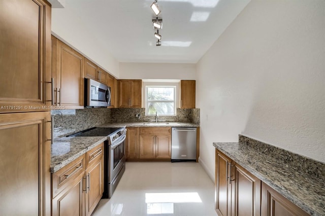 2600 S Ocean Dr Unit S314, Hollywood, FL 33019 - kitchen featuring decorative backsplash, stainless steel appliances, brown cabinets, a sink, and stone countertops