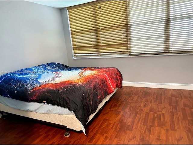 2150 Sans Souci Blvd Unit B611, North Miami, FL 33180 - bedroom featuring wood finished floors, multiple windows, and baseboards