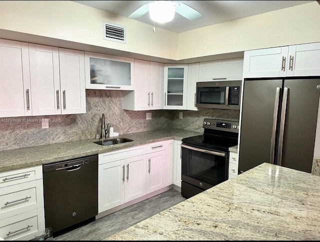 2150 Sans Souci Blvd Unit B611, North Miami, FL 33180 - kitchen featuring appliances with stainless steel finishes, a sink, ceiling fan, light stone counters, and white cabinetry