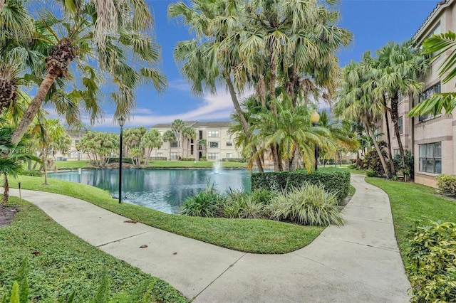 view of property's community featuring a yard and a water view
