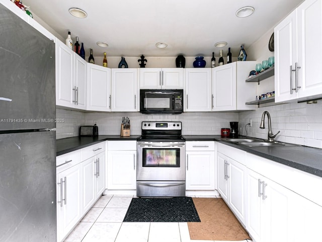 3242 Arthur St, Hollywood, FL 33021 - kitchen featuring dark countertops, appliances with stainless steel finishes, open shelves, a sink, and tasteful backsplash