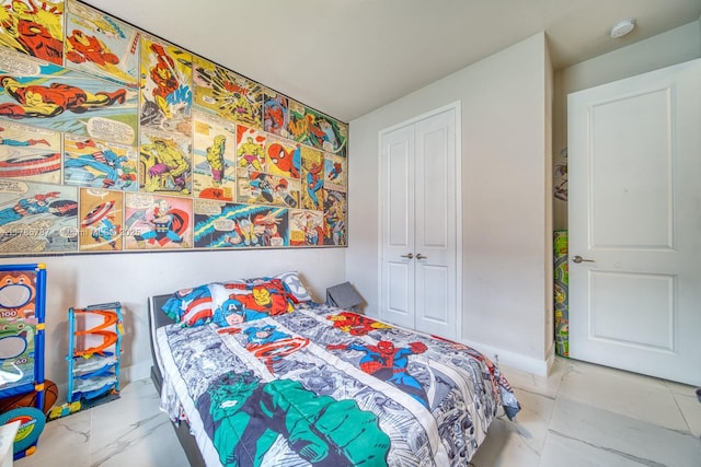 bedroom with a closet and marble finish floor