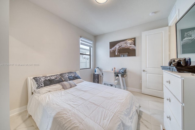 bedroom with baseboards and marble finish floor