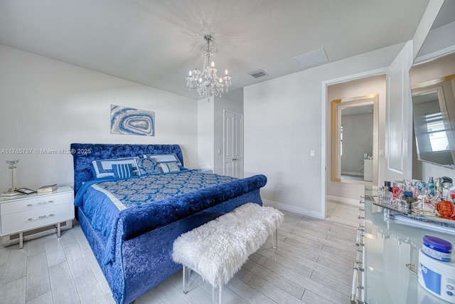 bedroom with visible vents, light wood-style flooring, and a chandelier