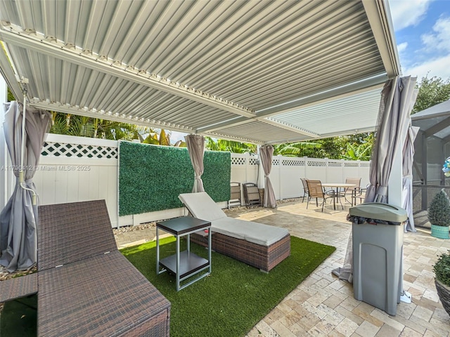 view of patio with outdoor dining space and a fenced backyard