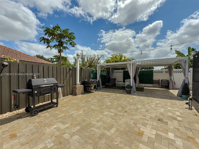 view of patio / terrace with a grill, a fenced backyard, and a pergola