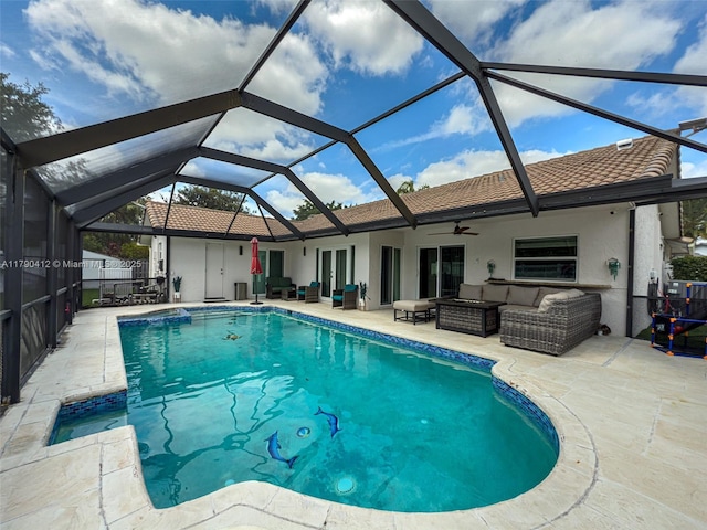 view of pool featuring a patio, a fenced in pool, outdoor lounge area, a ceiling fan, and a lanai