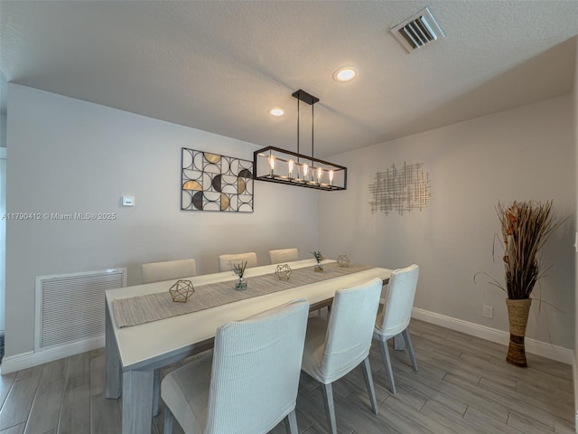 dining space featuring baseboards, visible vents, light wood-type flooring, and recessed lighting