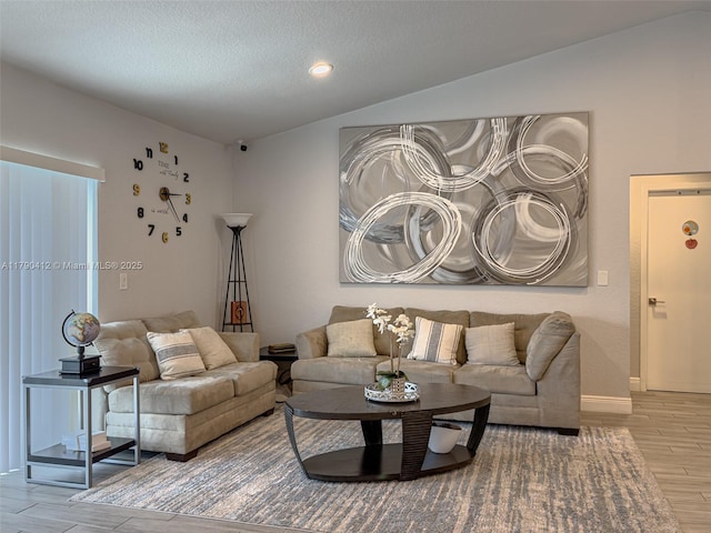 living area featuring recessed lighting, wood finished floors, baseboards, a textured ceiling, and lofted ceiling